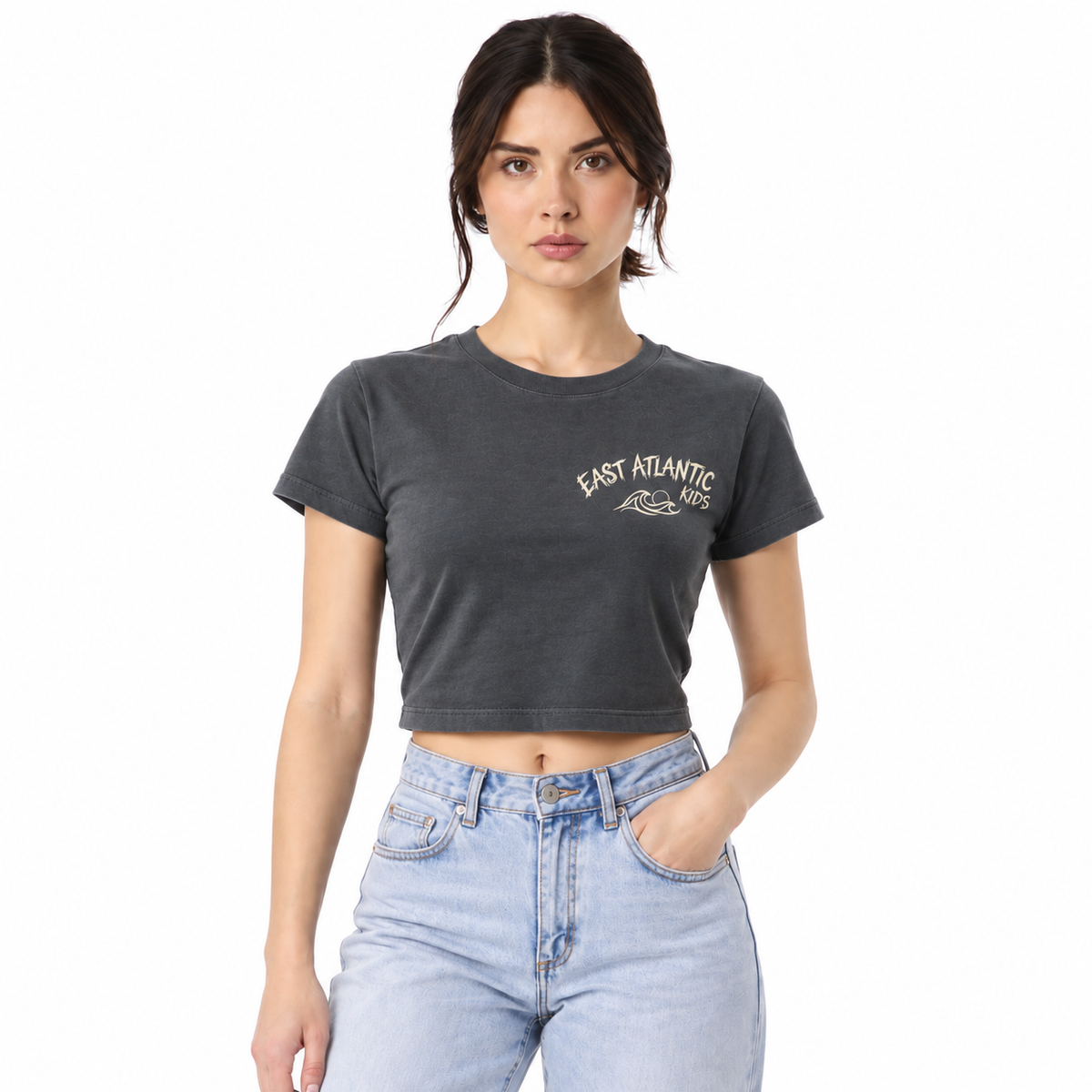 Woman wearing a trendy crop top paired with casual bottoms.
